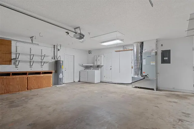 a view of a kitchen with refrigerator and cabinets