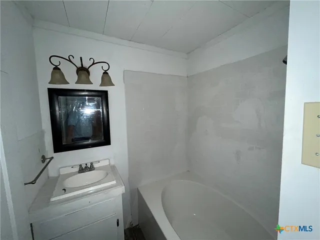 a bathroom with a bathtub and a sink