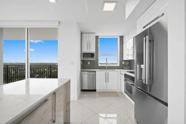 a kitchen with a refrigerator sink and stove