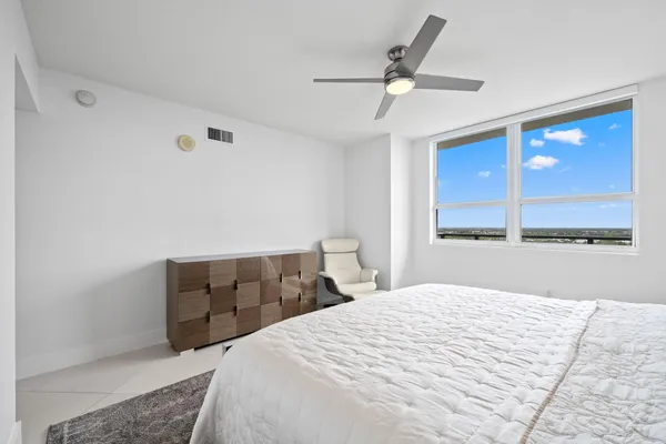 a bedroom with a large bed and a window