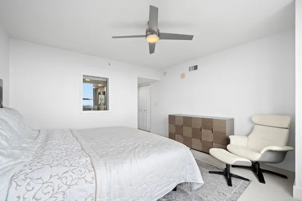 a bedroom with a bed and a chair
