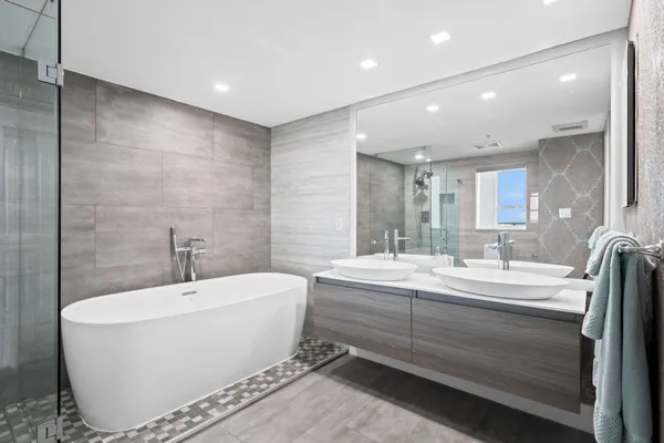 a bathroom with a large tub and sink
