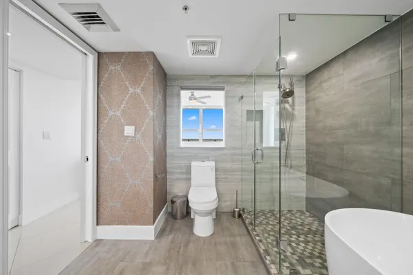 a bathroom with a toilet and a shower