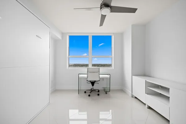 a work room with furniture and a window