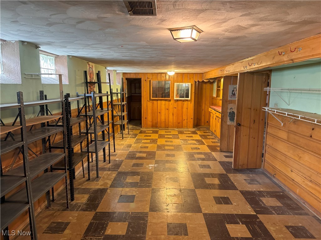 6271 Holburn Road Parma, OH 44129 - Photo 14 of 17 Basement with wooden walls and dark tile patterned floors