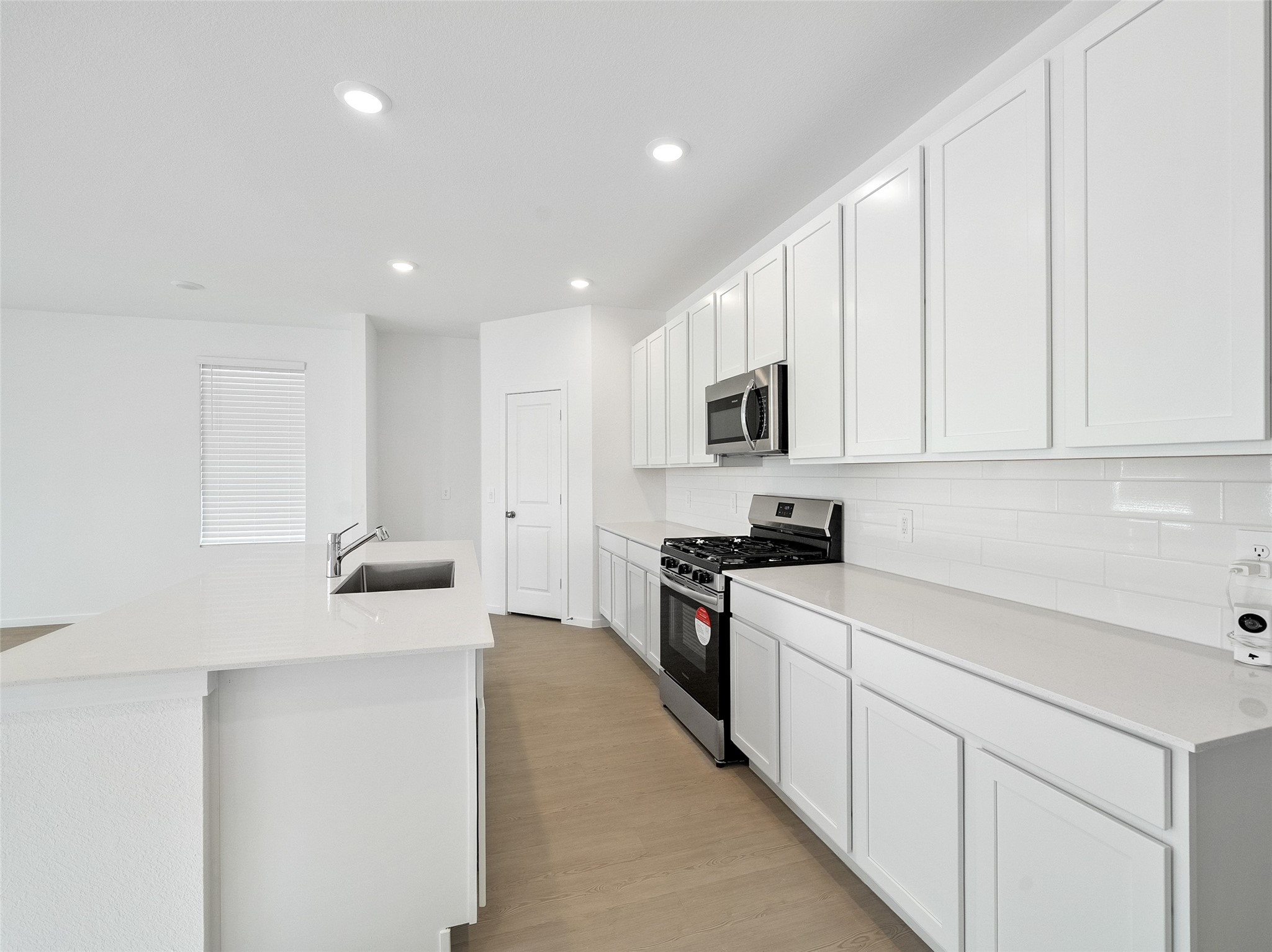 826 Ridgewood Cliffs Willis, TX 77378 - Photo 12 of 26 a kitchen with stainless steel appliances white cabinets and a refrigerator