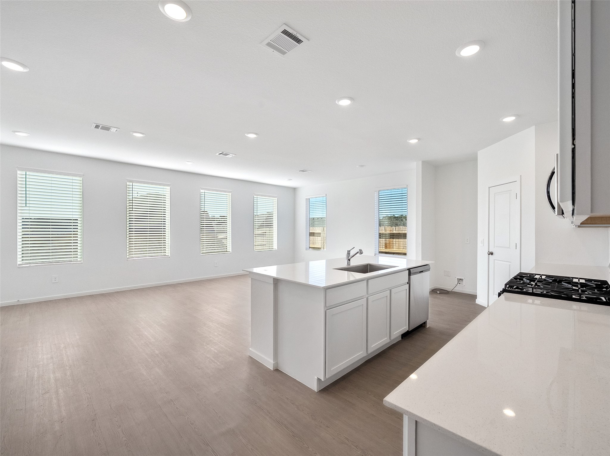 826 Ridgewood Cliffs Willis, TX 77378 - Photo 13 of 26 a large white kitchen with a sink stove and cabinets