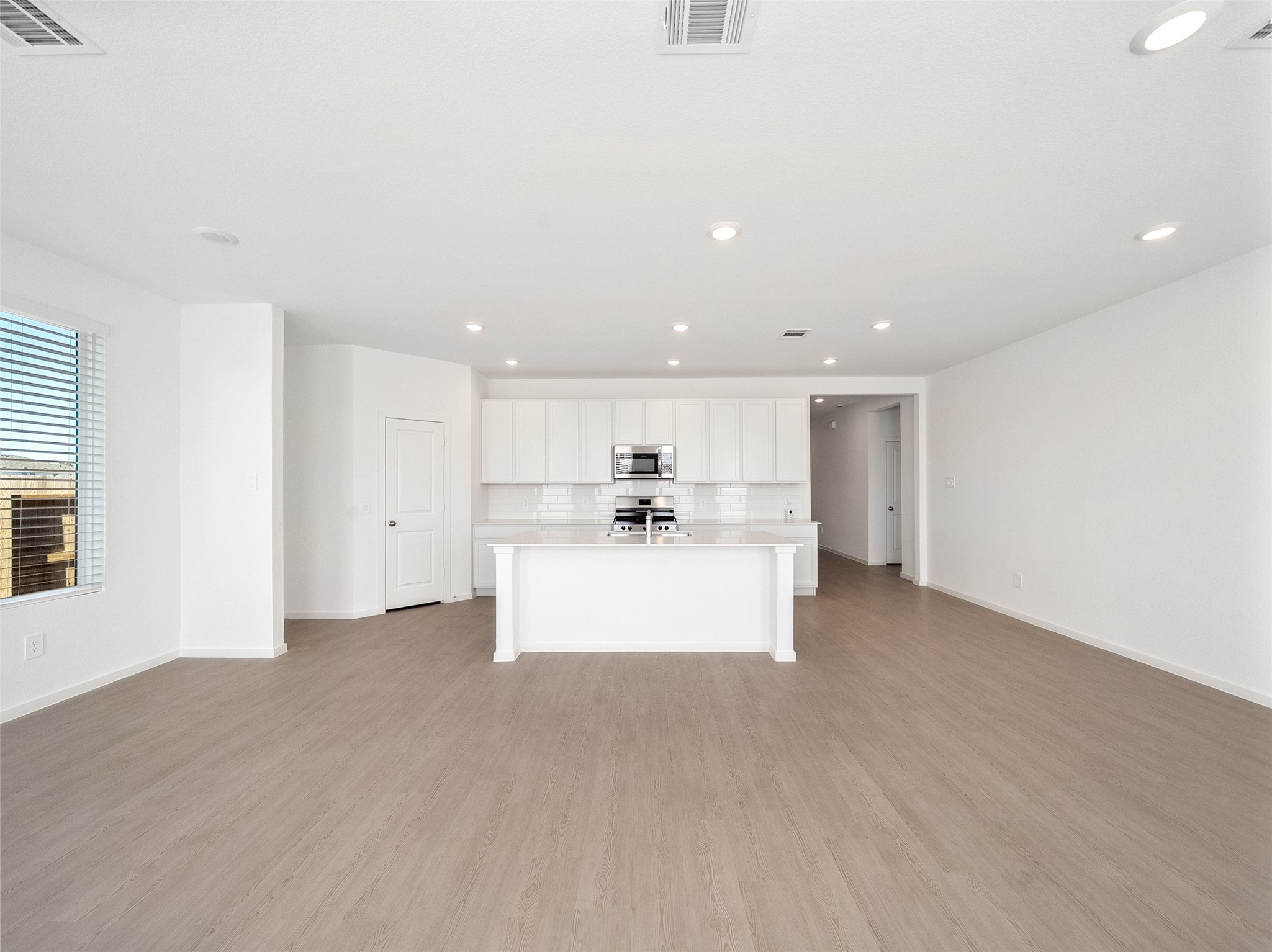 826 Ridgewood Cliffs Willis, TX 77378 - Photo 17 of 26 a view of kitchen with kitchen island a sink wooden floor and a refrigerator