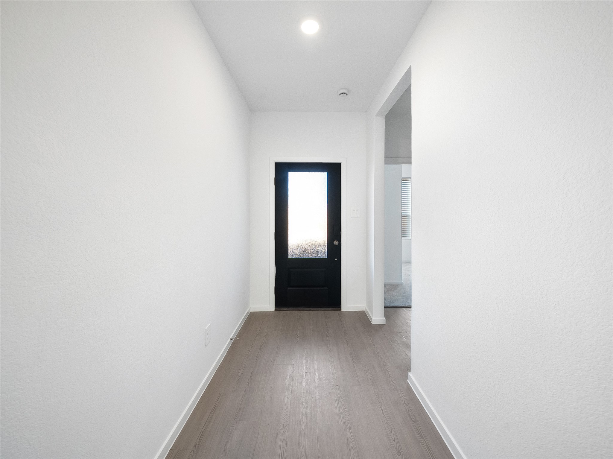 826 Ridgewood Cliffs Willis, TX 77378 - Photo 6 of 26 a view of a hallway with wooden floor