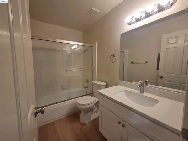 a bathroom with a shower a toilet and a sink