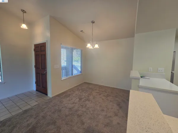 a view of a livingroom with a furniture and chandelier fan