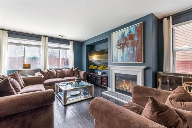 a living room with furniture large window and fireplace