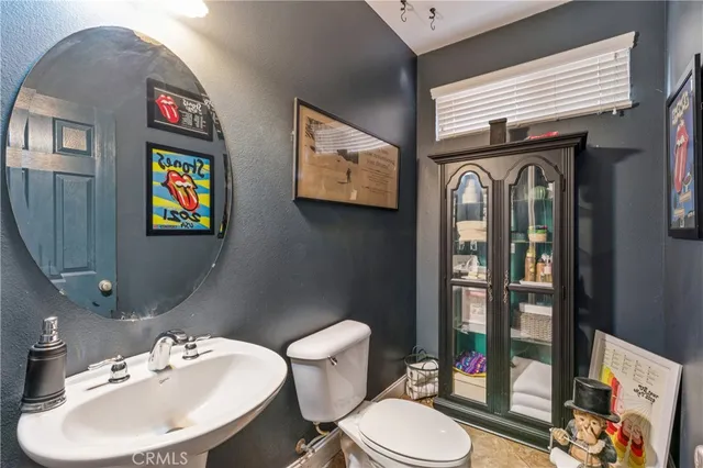 a bathroom with a toilet a sink and a mirror