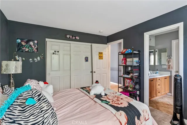 a bedroom with a bed and a book shelf