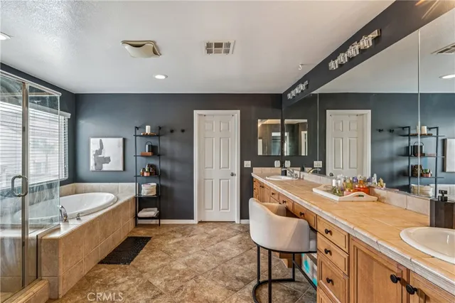 a large kitchen with kitchen island a large counter space and stainless steel appliances