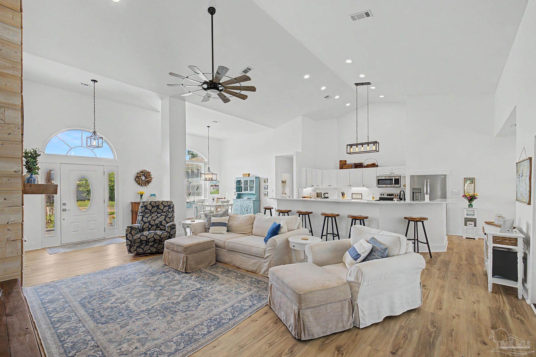 2005 Riviera Lane South Navarre, FL 32566 - Photo 5 of 70 a living room with furniture and a chandelier