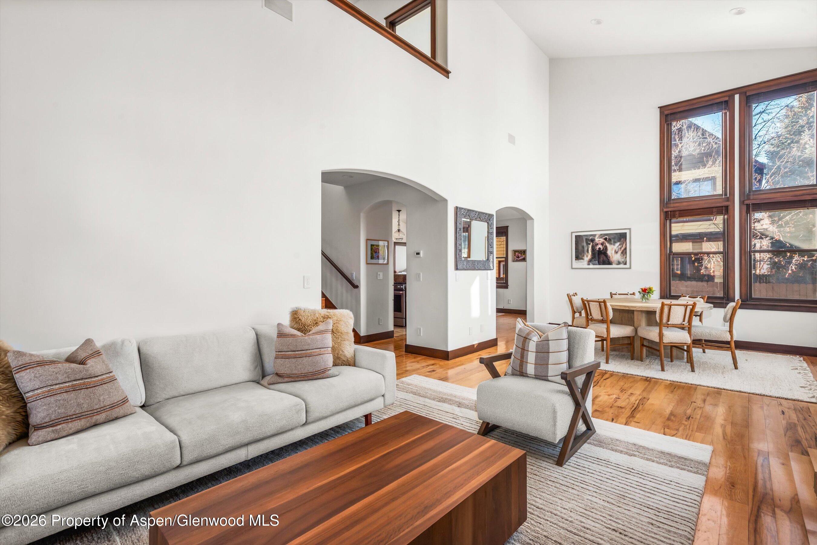 410 Meadow Court Basalt, CO 81621 - Photo 6 of 30 a living room with furniture wooden floor and a large window