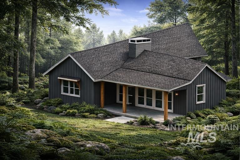 2 Valley High Road Garden Valley, ID 83622 - Photo 10 of 22 Rear view of house with board and batten siding, a shingled roof, a patio area, and a yard