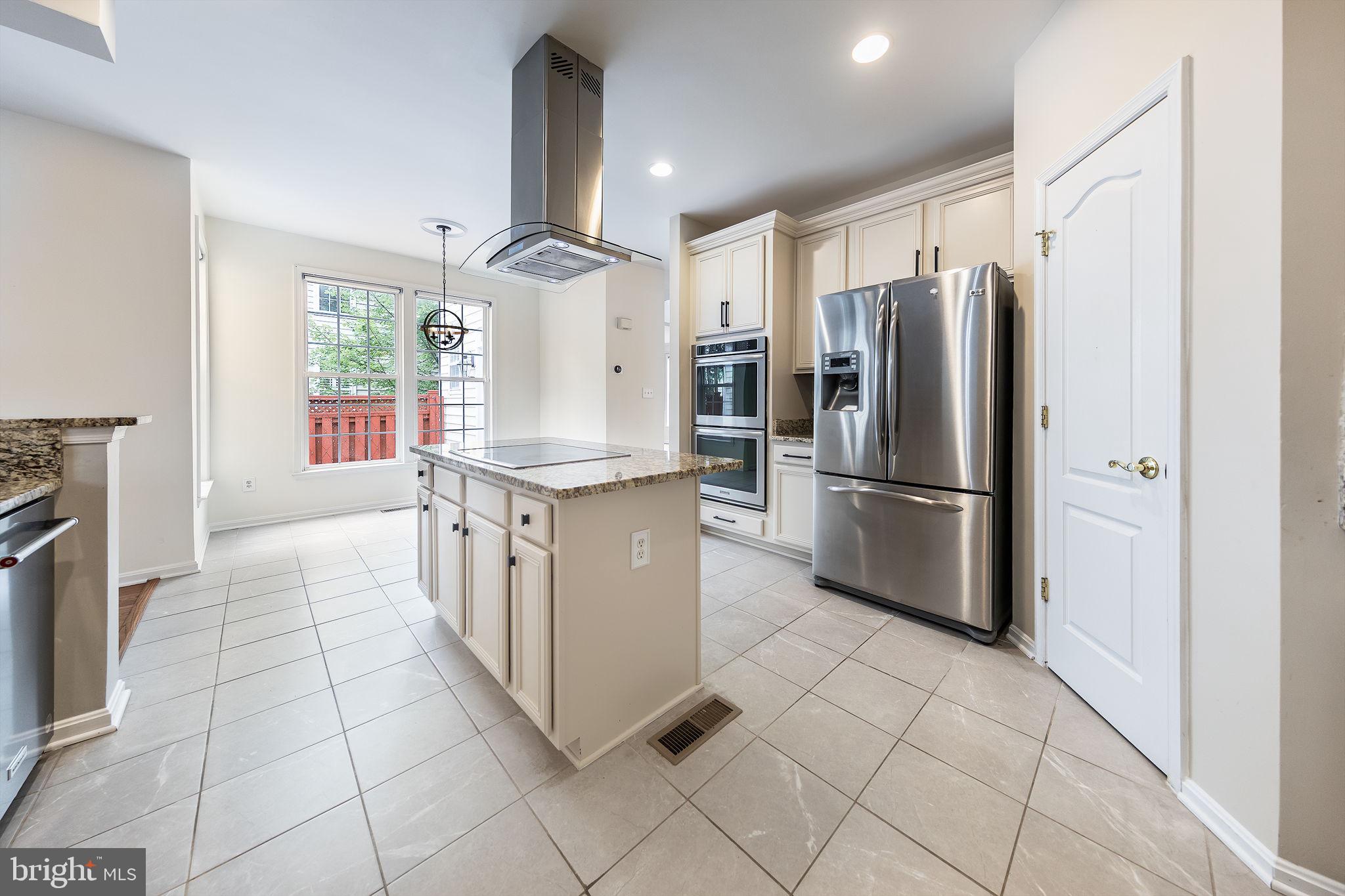 21934 Windover Drive Broadlands, VA 20148 - Photo 17 of 54 a kitchen with stainless steel appliances a refrigerator sink and microwave