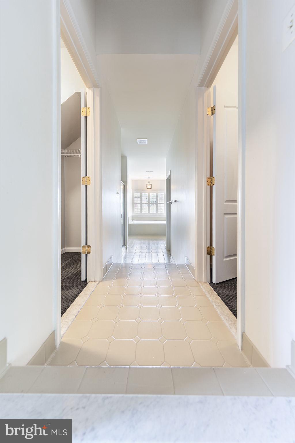 21934 Windover Drive Broadlands, VA 20148 - Photo 28 of 54 a large white bathroom with a large mirror