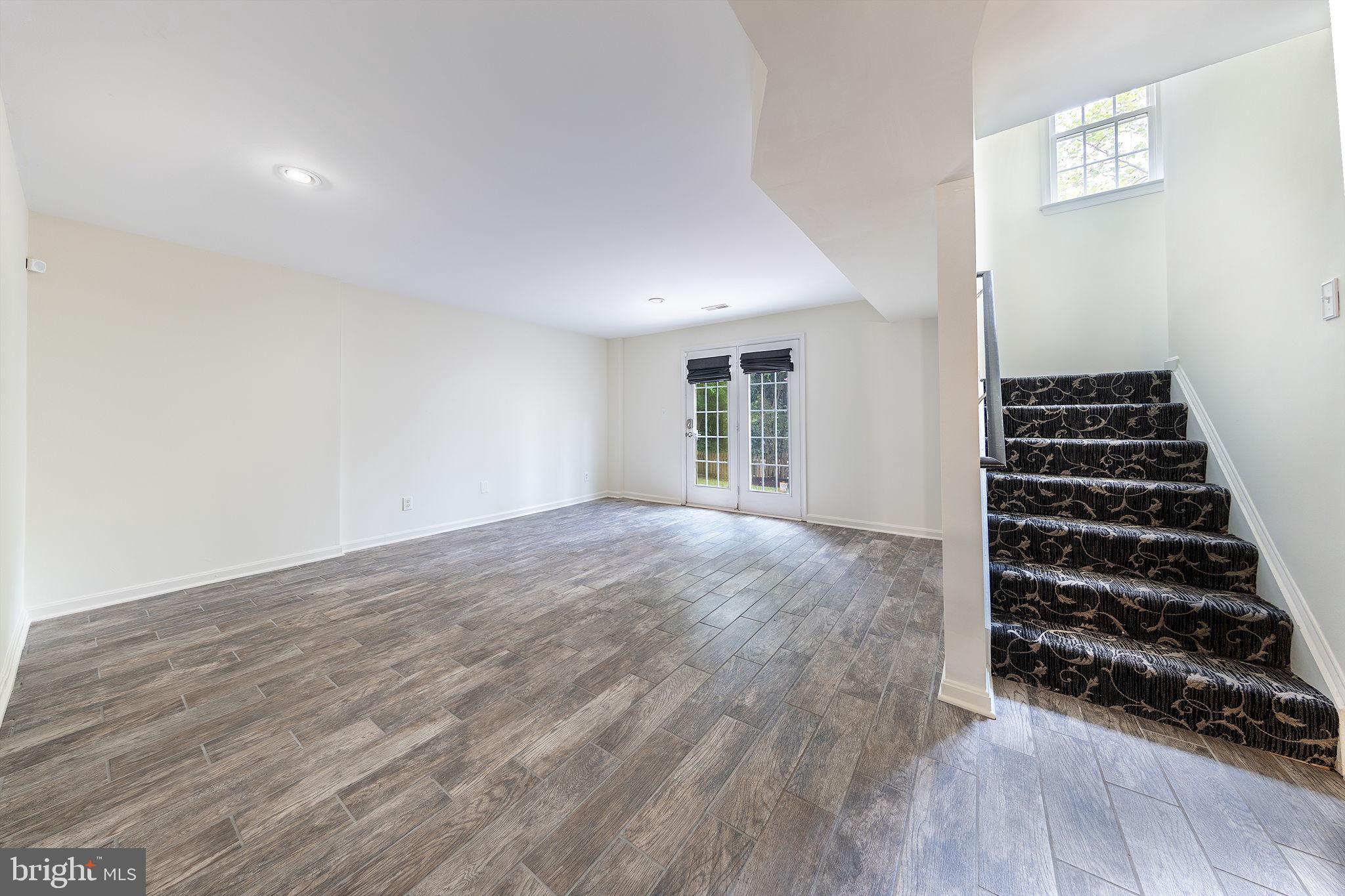 21934 Windover Drive Broadlands, VA 20148 - Photo 43 of 54 a view of an empty room with wooden floor windows and entryway