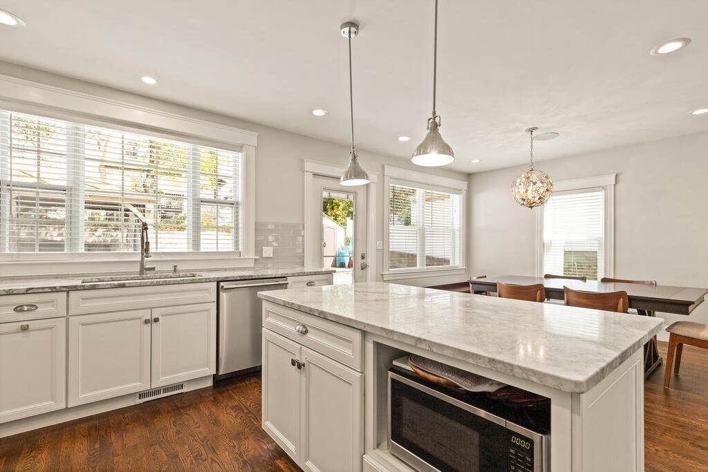 43 Guild Street Medford, MA 02155 - Photo 11 of 33 a kitchen with sink stove and cabinets