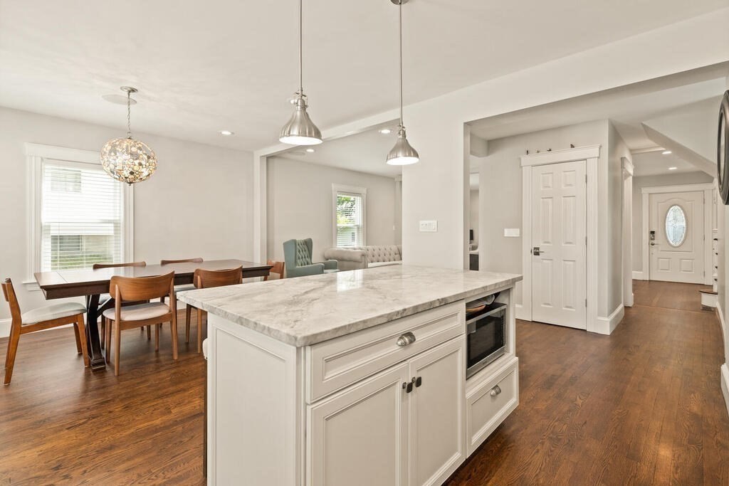 43 Guild Street Medford, MA 02155 - Photo 12 of 33 an open kitchen with a table and chairs