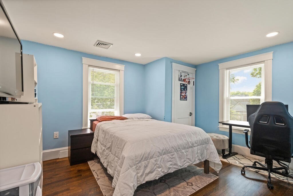 43 Guild Street Medford, MA 02155 - Photo 18 of 33 a bedroom with a bed a chair and a window