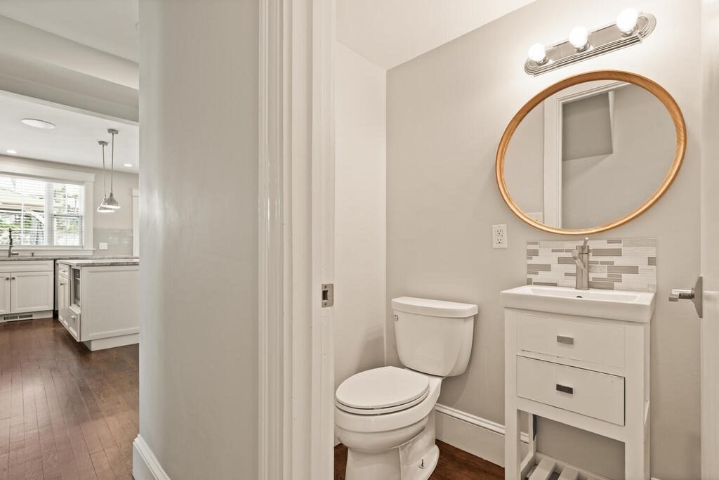 43 Guild Street Medford, MA 02155 - Photo 21 of 33 a bathroom with a toilet a sink and a mirror