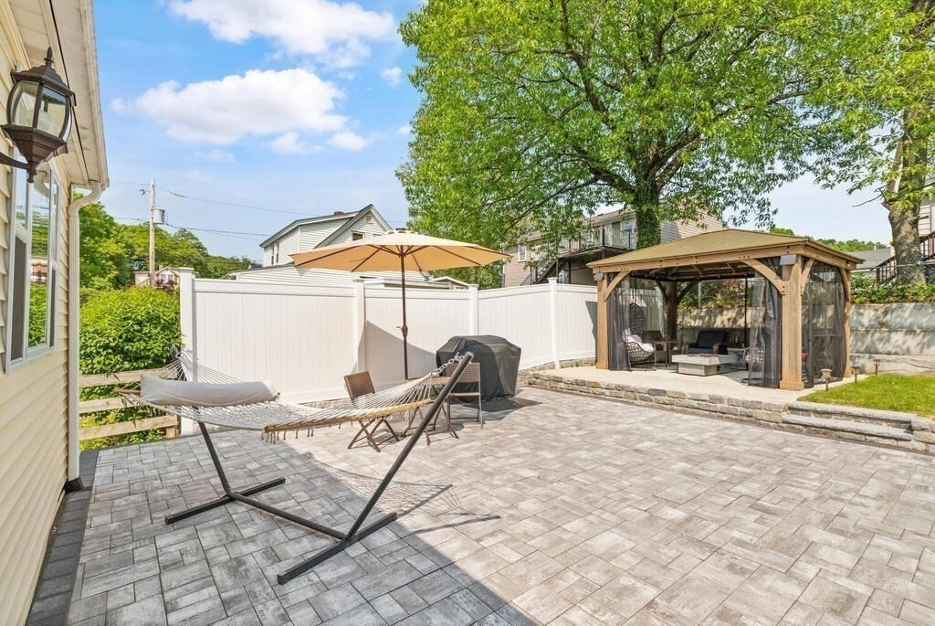 43 Guild Street Medford, MA 02155 - Photo 28 of 33 a view of a patio with table and chairs under an umbrella
