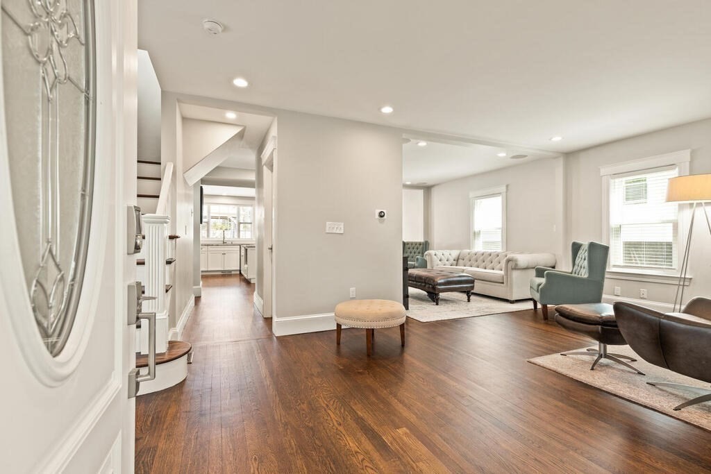 43 Guild Street Medford, MA 02155 - Photo 3 of 33 a living room with furniture a large window and wooden floor