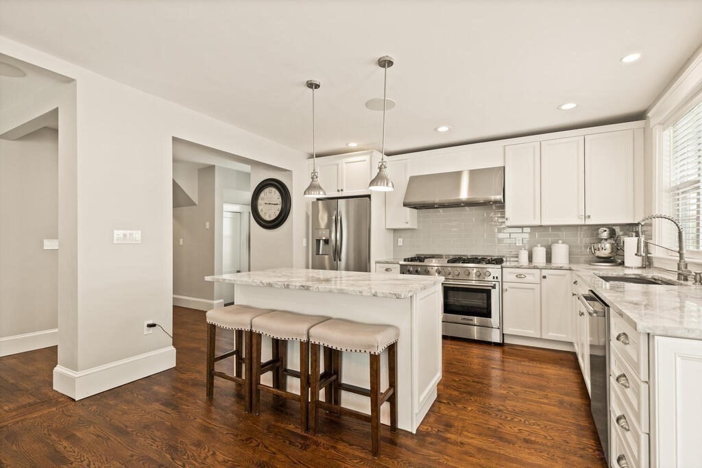 43 Guild Street Medford, MA 02155 - Photo 8 of 33 a large kitchen with a table and chairs