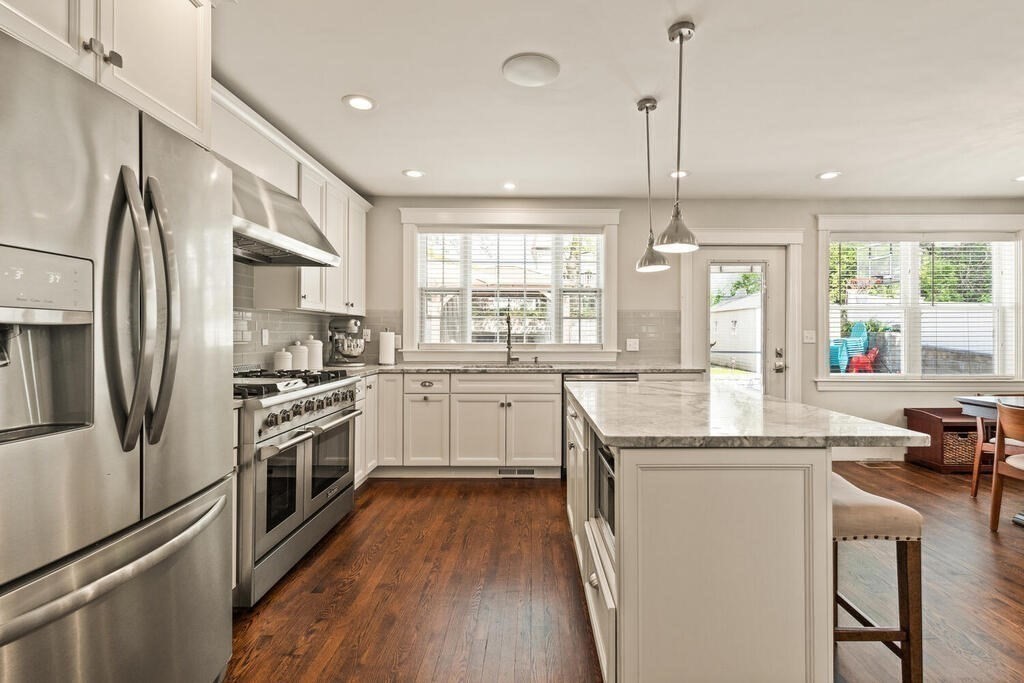 43 Guild Street Medford, MA 02155 - Photo 10 of 33 a kitchen with white cabinets sink and stainless steel appliances