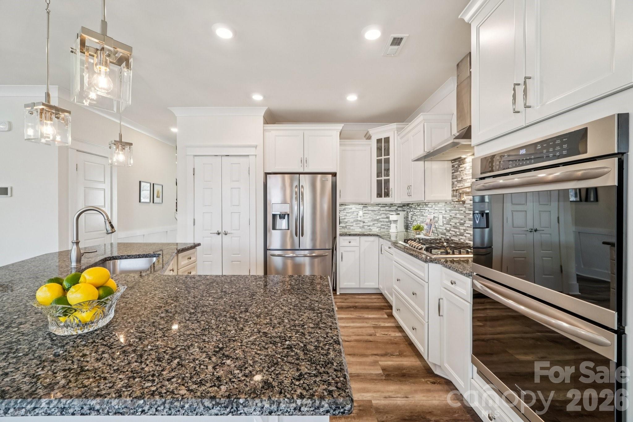 4093 Clapton Drive Lancaster, SC 29720 - Photo 14 of 48 a kitchen with stainless steel appliances granite countertop a stove a sink and a refrigerator