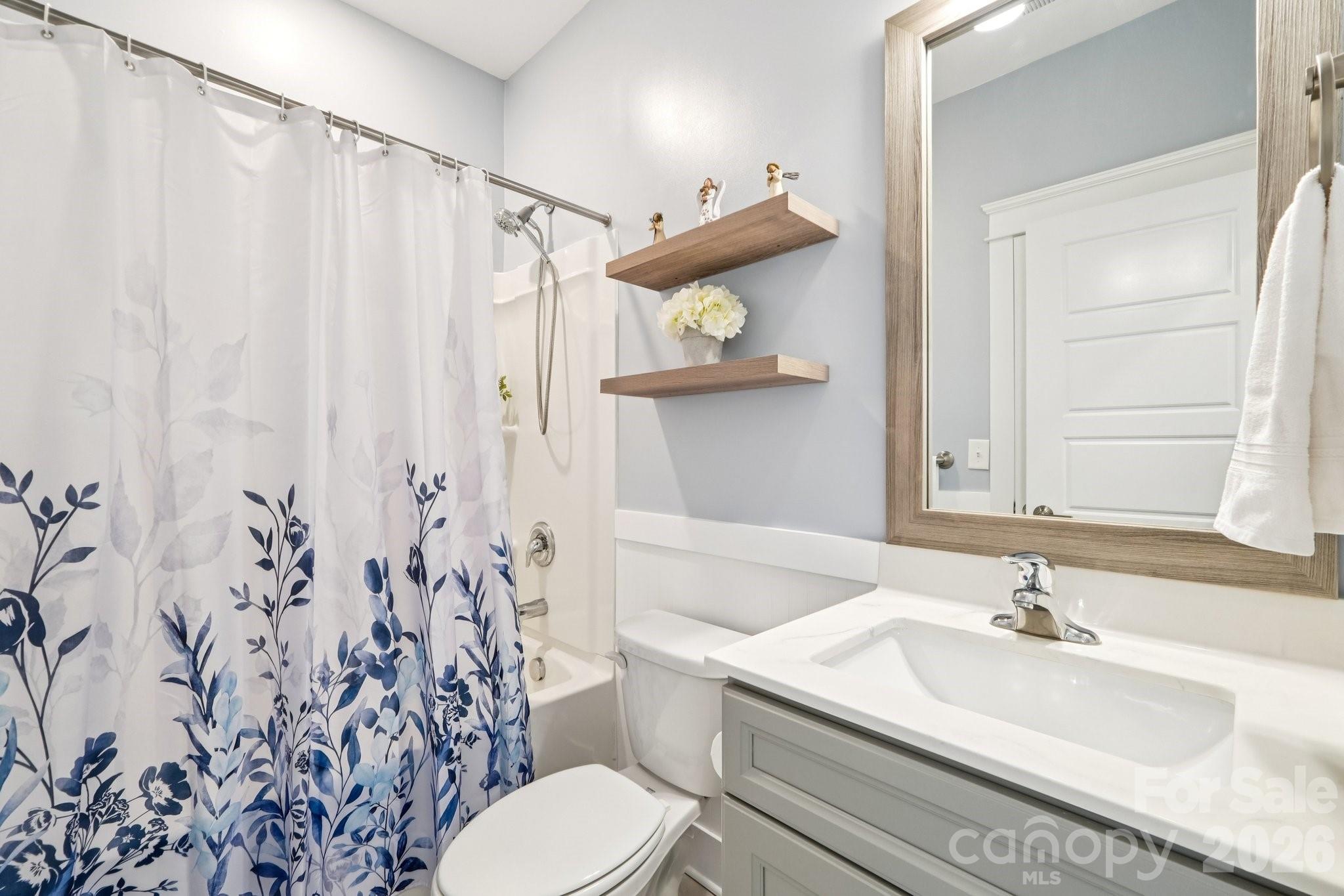 4093 Clapton Drive Lancaster, SC 29720 - Photo 17 of 48 a bathroom with a sink a toilet and shower curtain