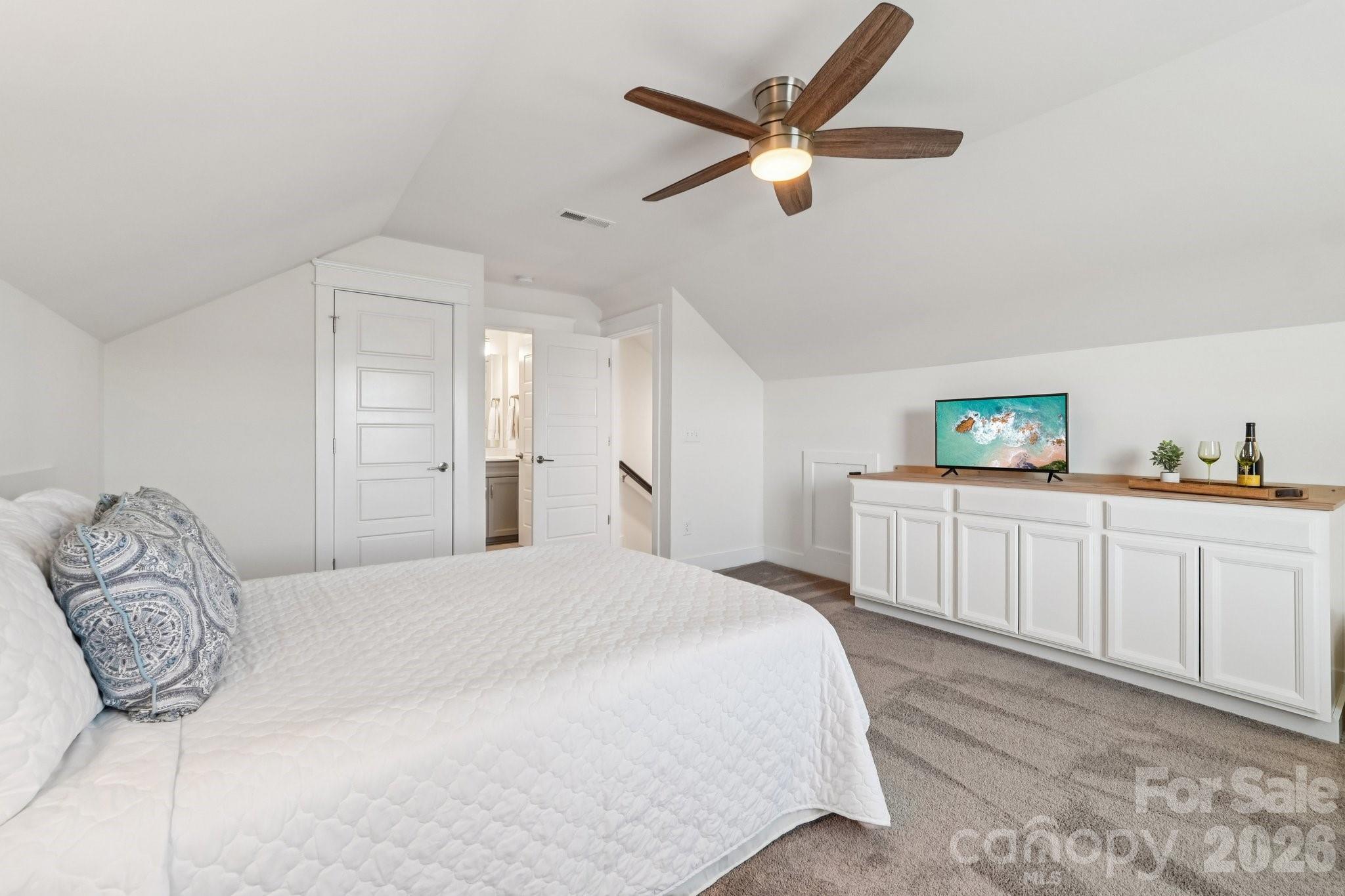4093 Clapton Drive Lancaster, SC 29720 - Photo 35 of 48 a bedroom with a large bed and a chandelier
