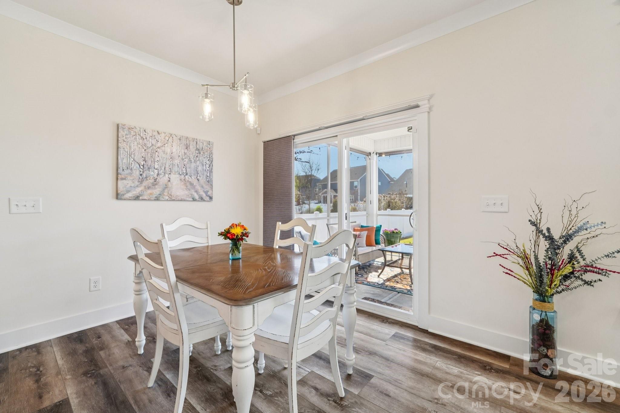 4093 Clapton Drive Lancaster, SC 29720 - Photo 8 of 48 a dining room with furniture potted plants and wooden floor