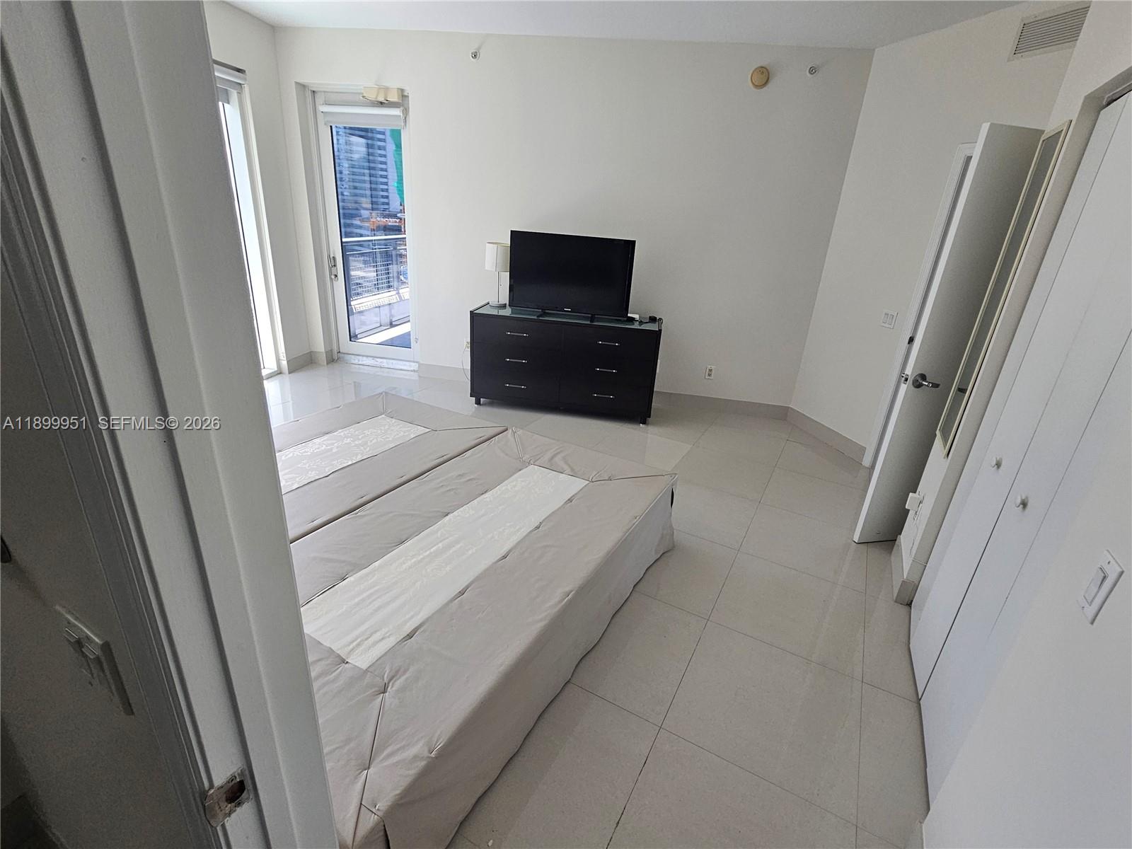 60 Southwest 13th Street, Unit 1900 Miami, FL 33130 - Photo 34 of 96 a living room with a flat screen tv and a refrigerator