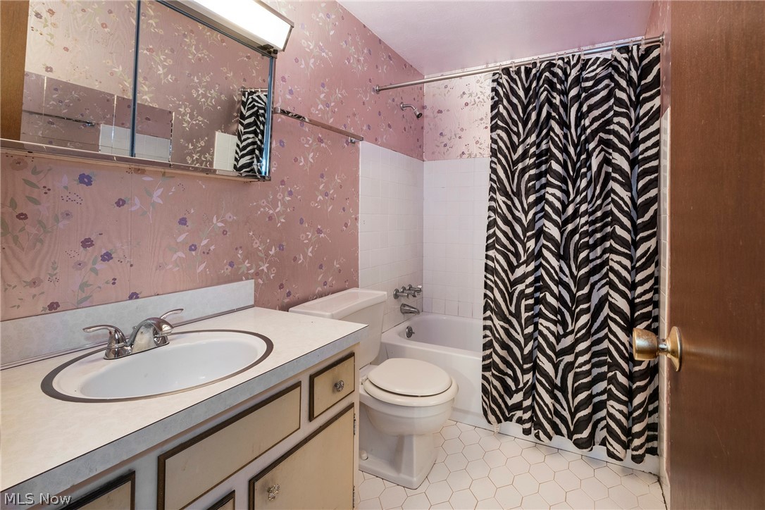 6484 State Road Parma, OH 44134 - Photo 22 of 36 Full bathroom serving the bedrooms with tile flooring and tiled shower surround.
