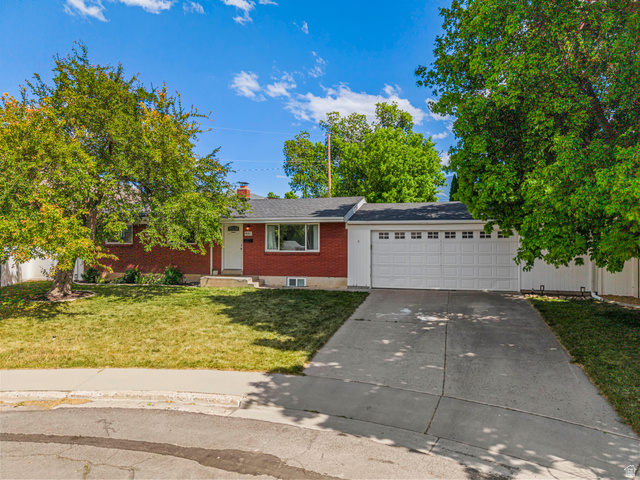 480 North 150 E Street Springville, UT 84663 - Photo 8 of 36 Brick exterior with a two-car garage, concrete driveway, and a front lawn