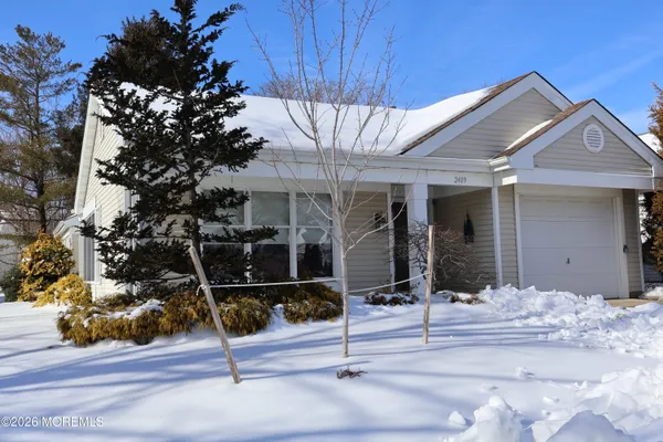 a view of a house with wooden fence