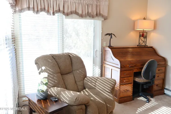 a living room with furniture a window and a lamp
