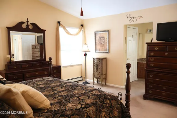 a bedroom with a bed and a television