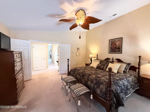 a bedroom with bed and a chandelier