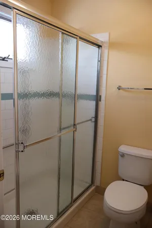 a bathroom with a toilet and a shower