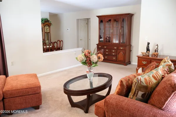 a living room with furniture and a mirror