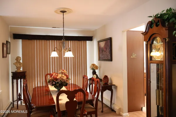 a view of a dining room with furniture and chandelier