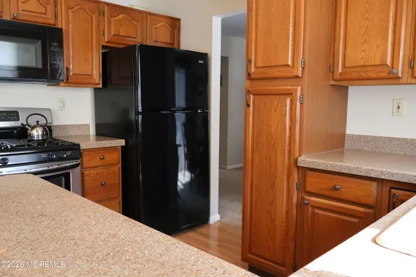 a kitchen with a refrigerator stove and cabinets