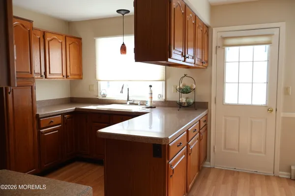 a kitchen with stainless steel appliances granite countertop a sink and a stove