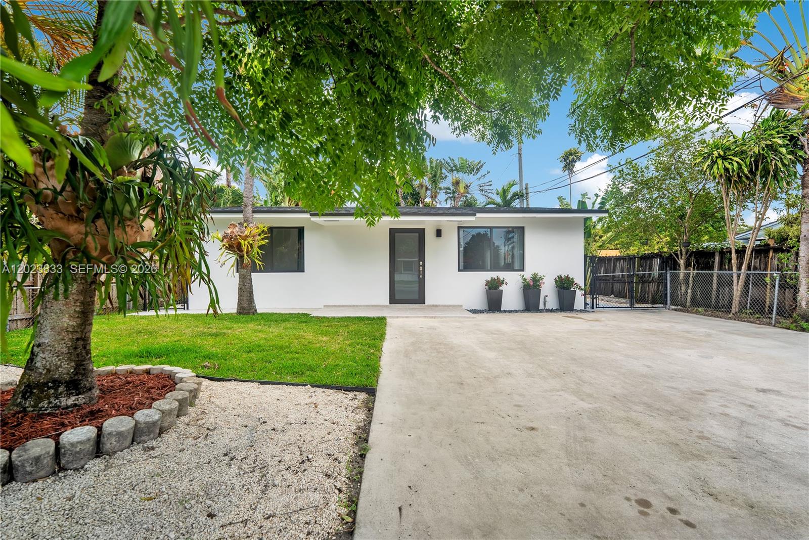 6566 Southwest 35th Street Miami, FL 33155 - Photo 2 of 36 a view of a backyard with a garden and tree